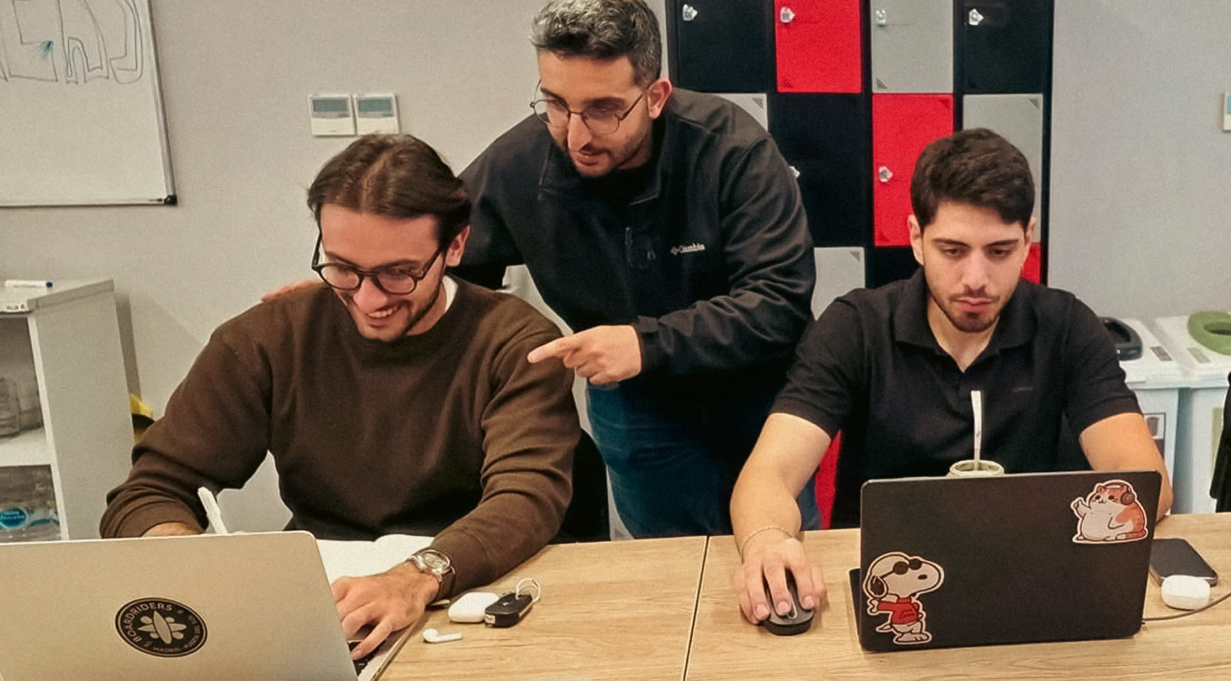 Three members of the Callers team working together at one desk